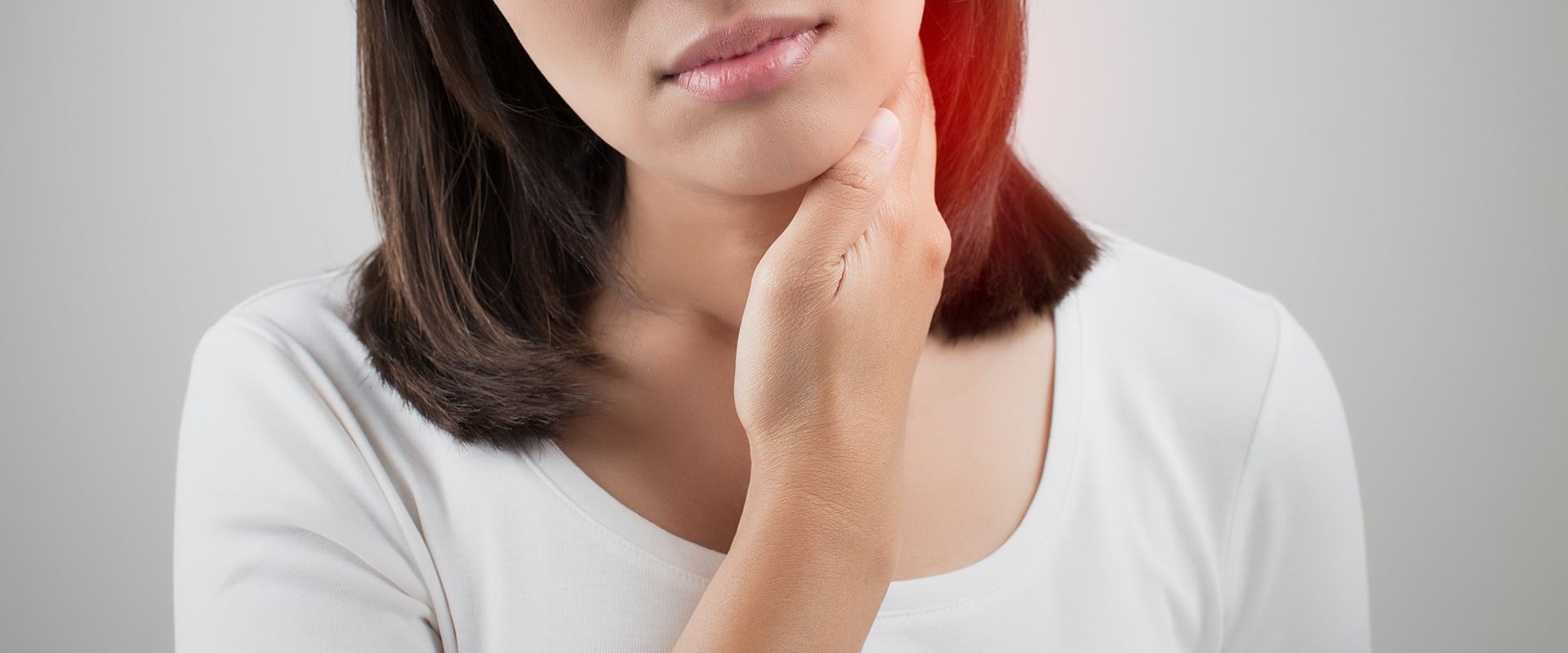Woman holding her neck near thyroid